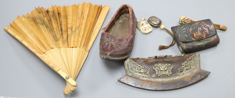 A Japanese ruyi sceptre okimono, together with a stamped leather tobacco pouch, a tinder strike, a leather Chinese childs shoe, a fan,